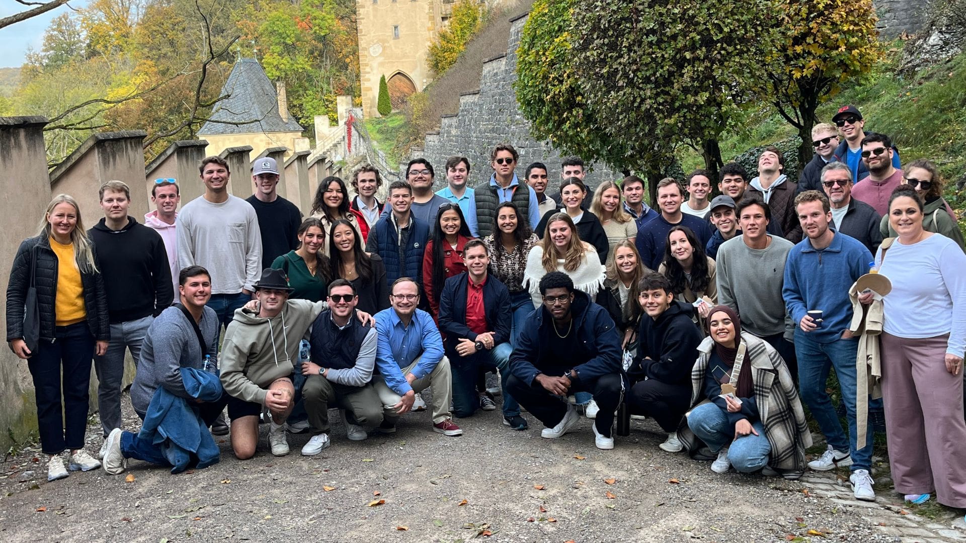 early advantage cohort 43 stands outside of karlstejn castle in the czech republic