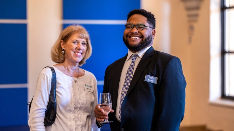 Two alumni networking at an event.