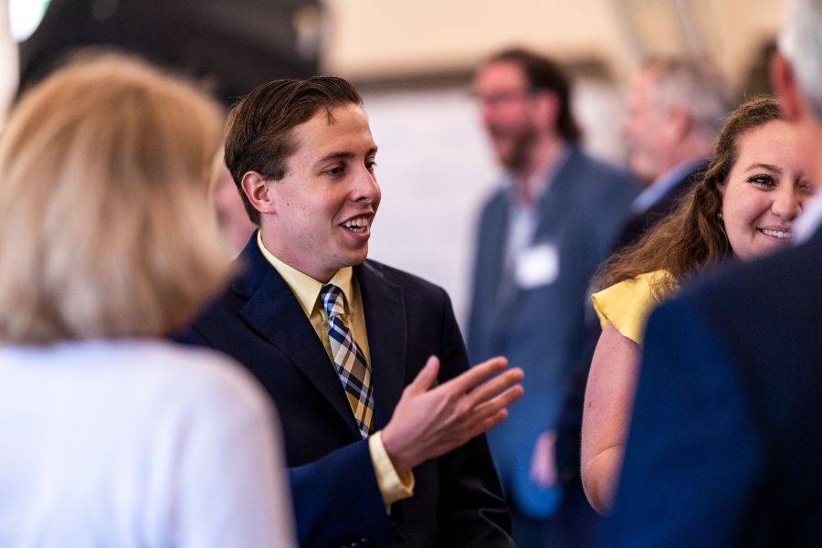 crummer ambassador gestures toward another student