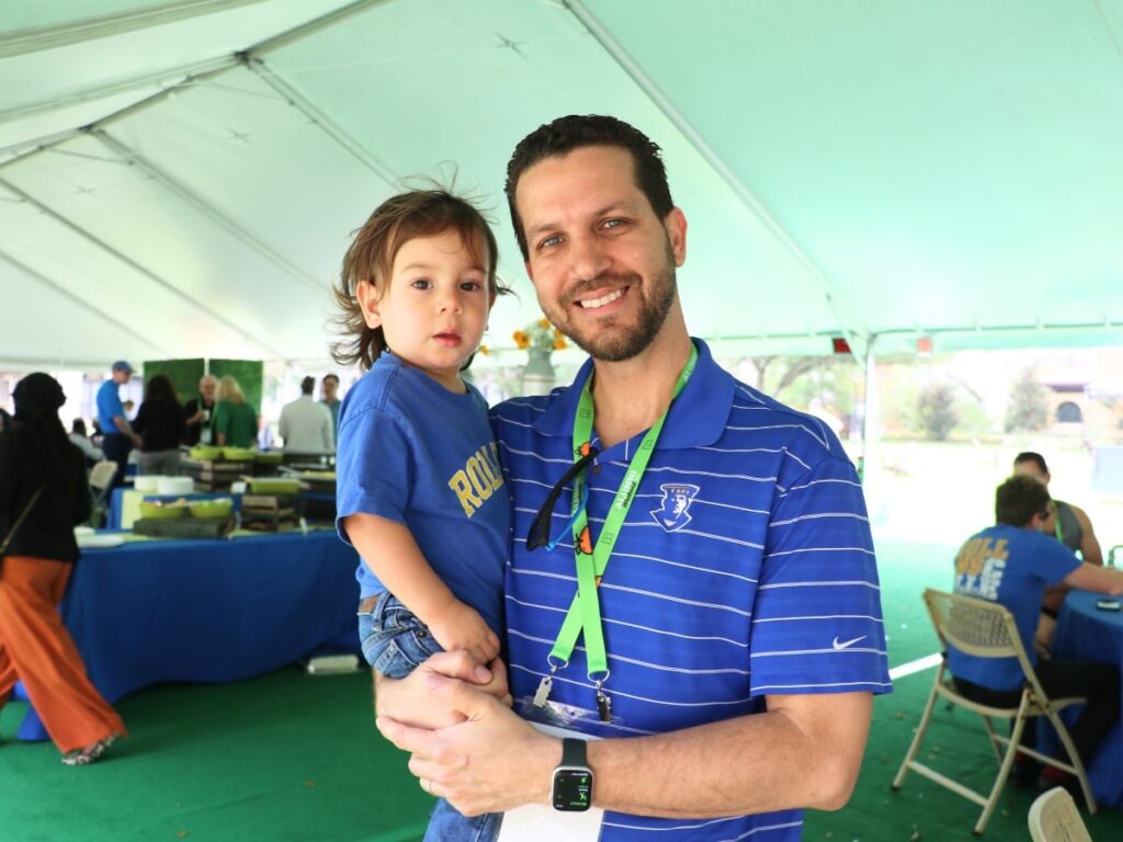 Crummer alumni and son sporting Rollins gear at Alumni Weekend.