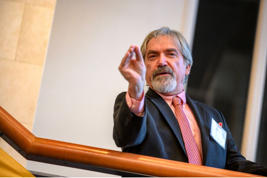 theater professor gestures toward the audience with his hand