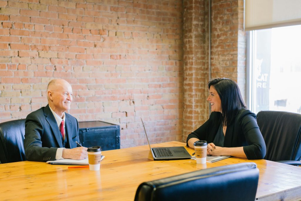 Two executives discussing strategy in a modern office.